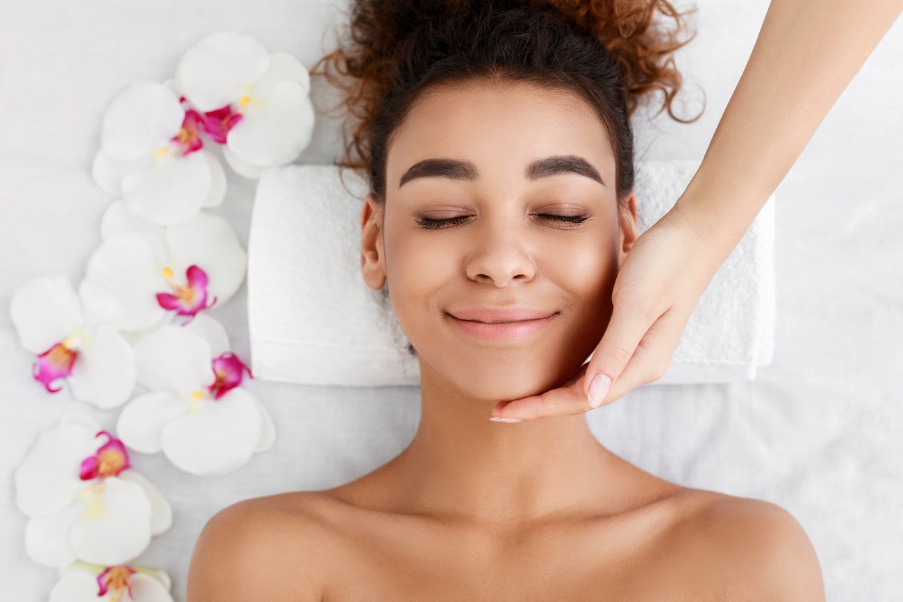 african american woman getting face massage at bea XMD6JE2