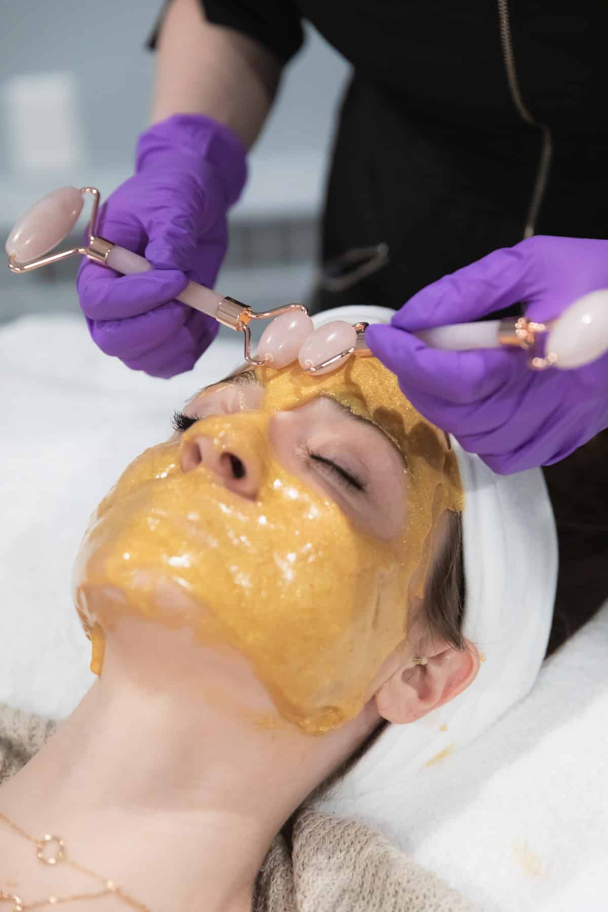 woman getting her whole face waxed
